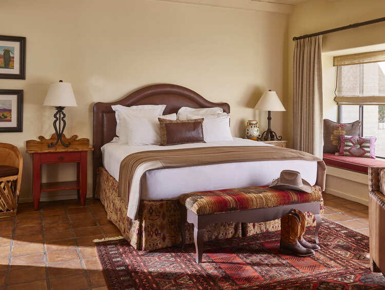 King bed with side table and light coming into room