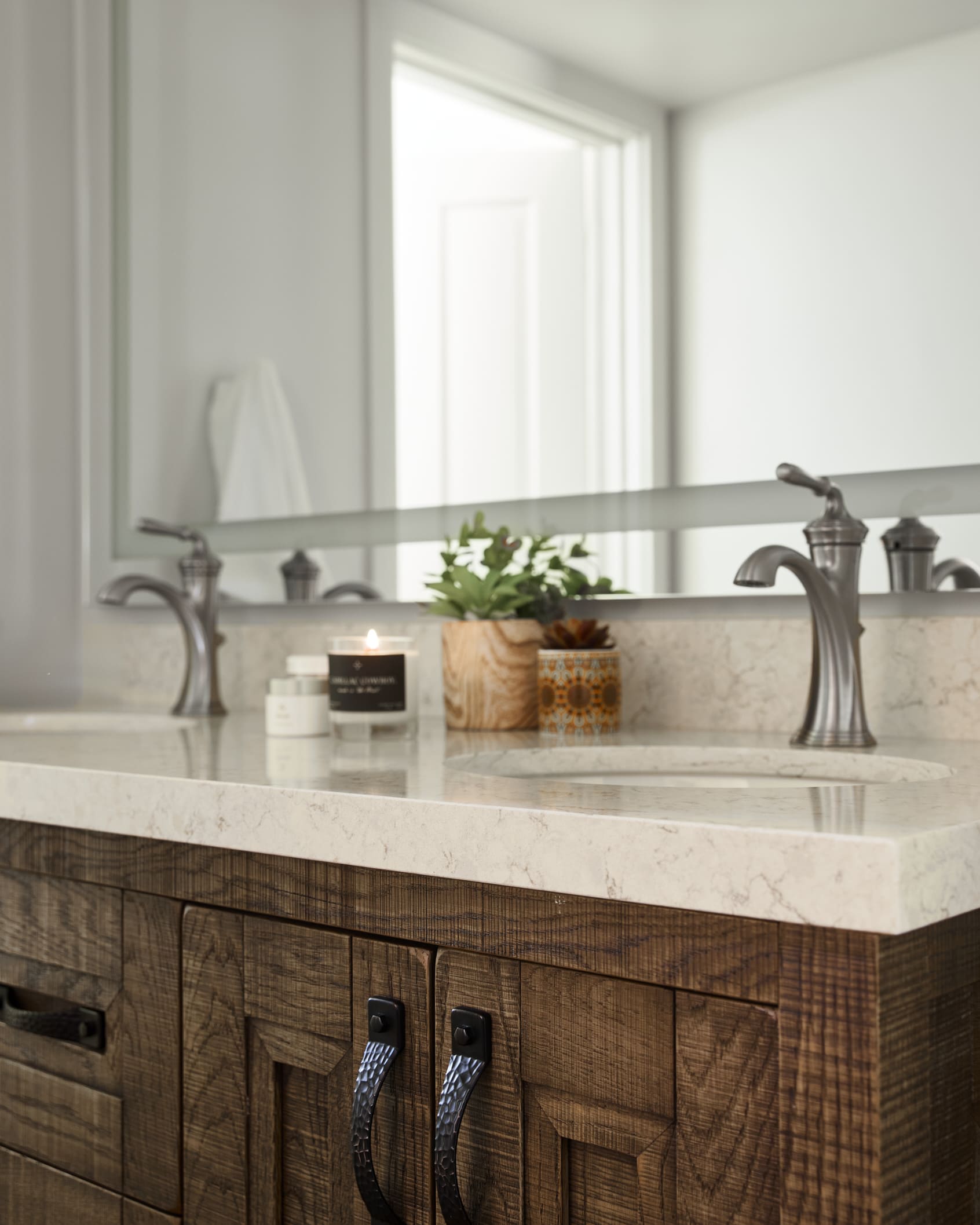 Sink, counter, and chair in front of mirror