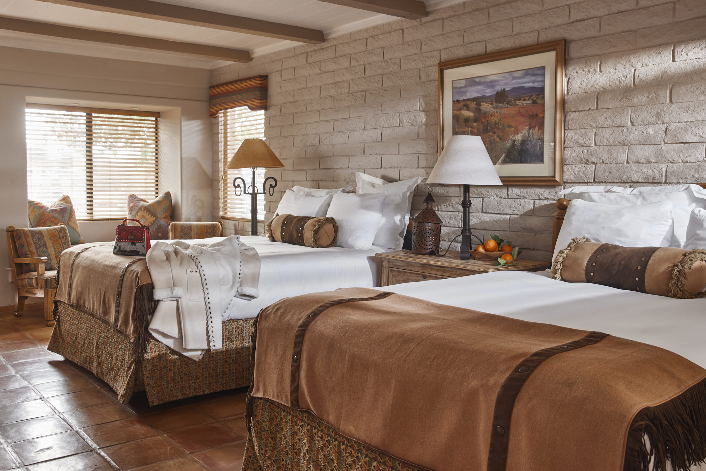 King bed with chair and sun beaming into room