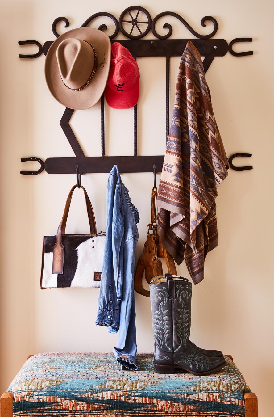 Clothes hanger with hat, shirt, and scarf hung on hooks